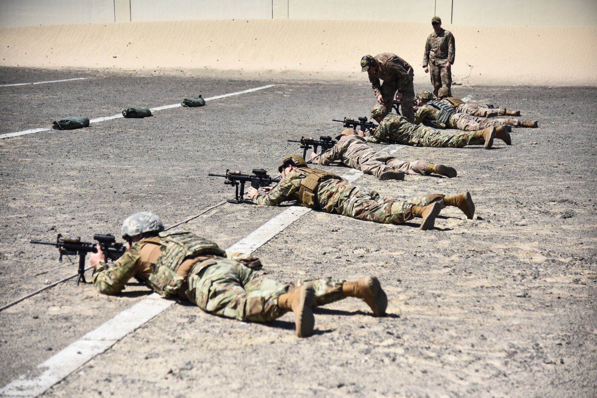 Airmen assigned to the 380th Expeditionary Security Forces Squadron fire their M4 Carbine weapons at Al Dhafra Air Base, United Arab Emirates, March 8, 2019. The 380th ESFS members used the method of “zeroing” their weapons – firing live rounds to ensure the accuracy as opposed to the method of bore sighting – a less reliable technique. (U.S. Air Force photo by Senior Airman Mya M. Crosby)
