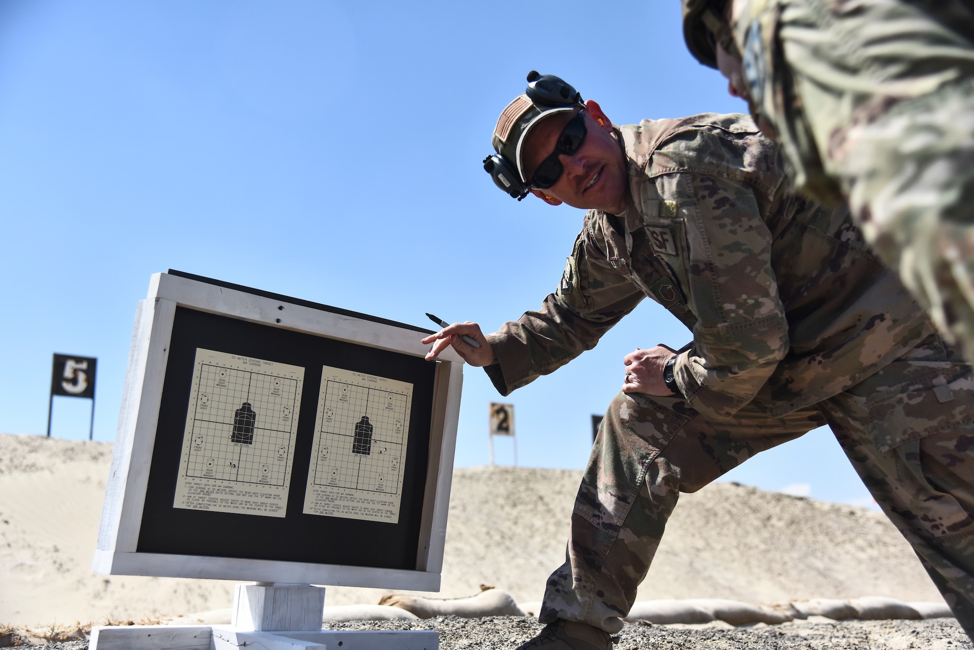 Master Sgt. Kurt Musson, 380th Expeditionary Security Forces Squadron NCO in charge of combat arms, provides sight corrections at Al Dhafra Air Base, United Arab Emirates, March 8, 2019. The 380th ESFS members used the method of “zeroing” their weapons – firing live rounds to ensure the accuracy as opposed to the method of bore sighting – a less reliable technique. (U.S. Air Force photo by Senior Airman Mya M. Crosby)