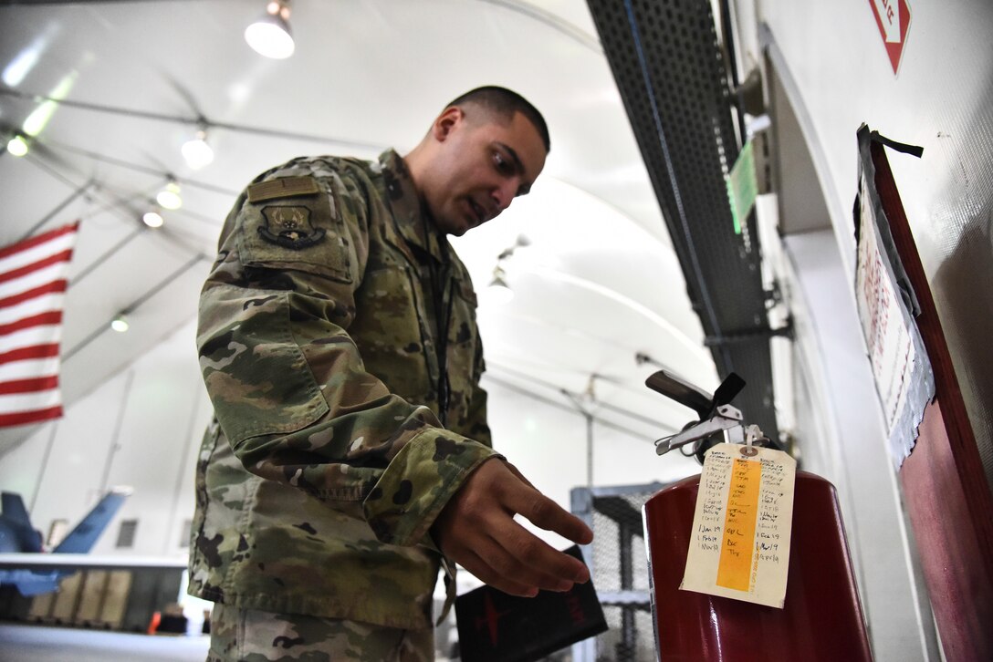 Staff Sgt. Luis Rosa, 380th Expeditionary Maintenance Group RQ-4 Global Hawk and U-2 Dragon Lady quality assurance inspector, inspects a fire hydrant in an aircraft hangar at Al Dhafra Air Base, United Arab Emirates, March 12, 2019. QA Airmen serve as the primary technical advisory agency in the maintenance organization, assisting maintenance supervision at all levels to identify, validate and/or resolve workmanship, proficiency and/or compliance issues impacting mission generation. (U.S. Air Force photo by Senior Airman Mya M. Crosby)