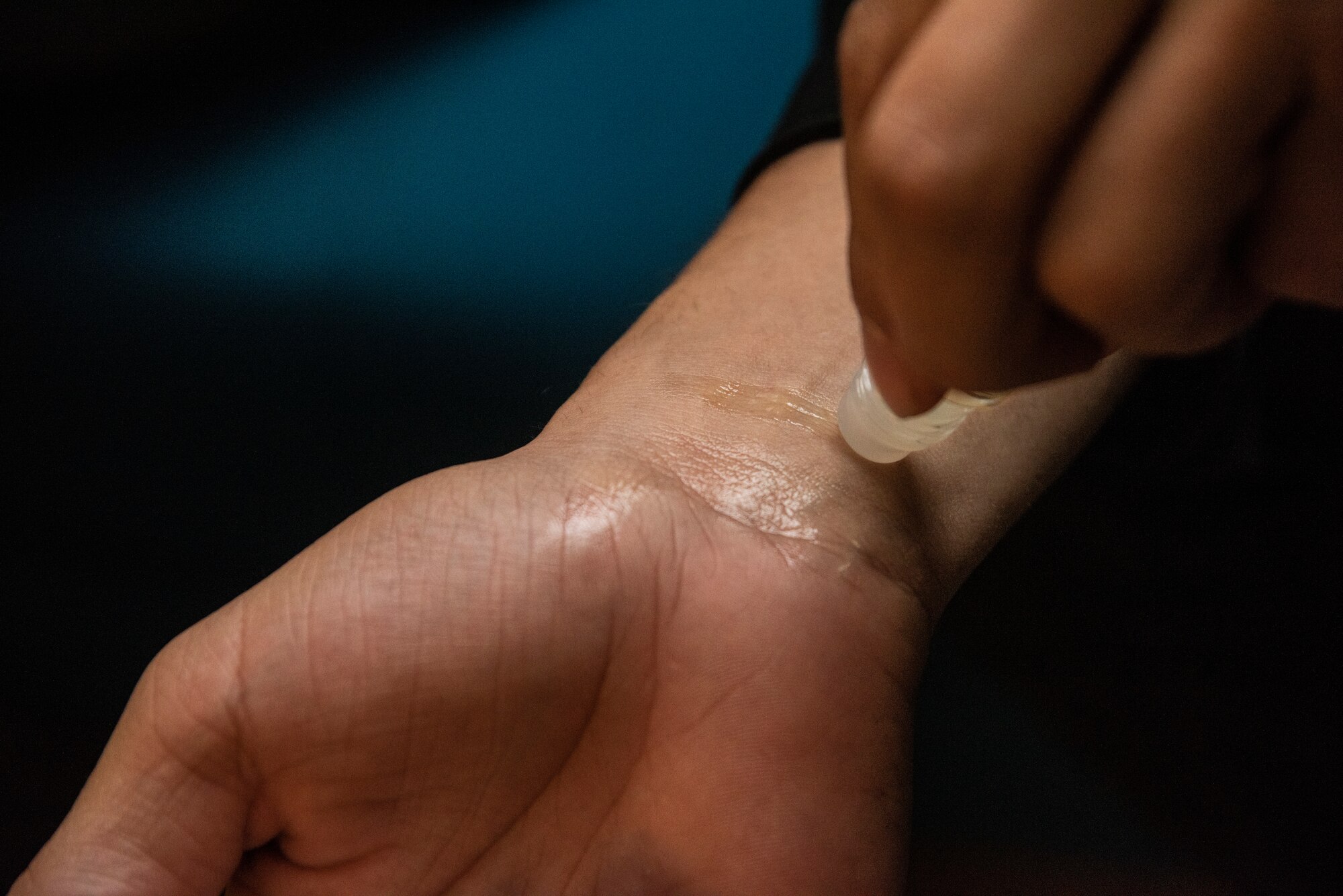 U.S. Air Force Senior Airman Dylan White, a 35th Security Forces Squadron military working dog handler, tests his new lavender oil roller on his wrist during an essential oils class at Misawa Air Base, Japan, March 12, 2019. White, along with eight other attendees received free oil samples and talked with each other, hearing stories of how others used oils in their home. (U.S. Air Force photo by Senior Airman Sadie Colbert)