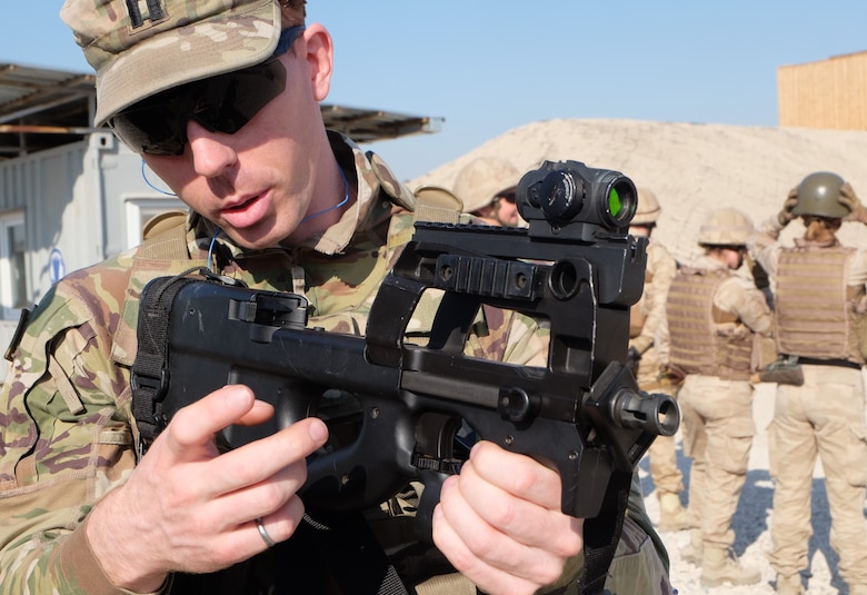 CPT Nick Caesar trains on the FN P90 compact weapon.
