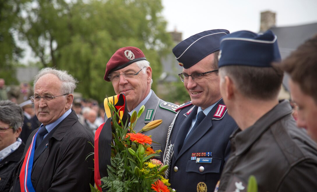 U.S., German and French dignitaries at a ceremony in Picauville, France