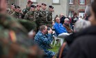 Multinational military and civilians in a ceremony in Picauville, France