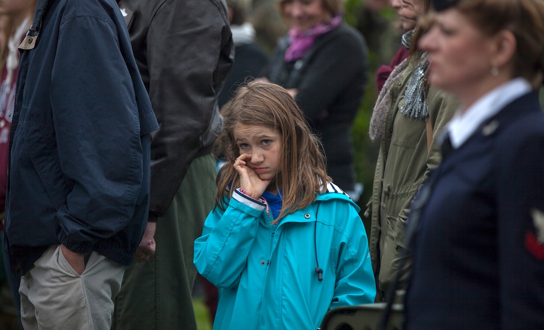 Multinational military and civilians in a ceremony in Picauville, France