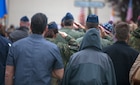 Multinational military and civilians in a ceremony in Picauville, France