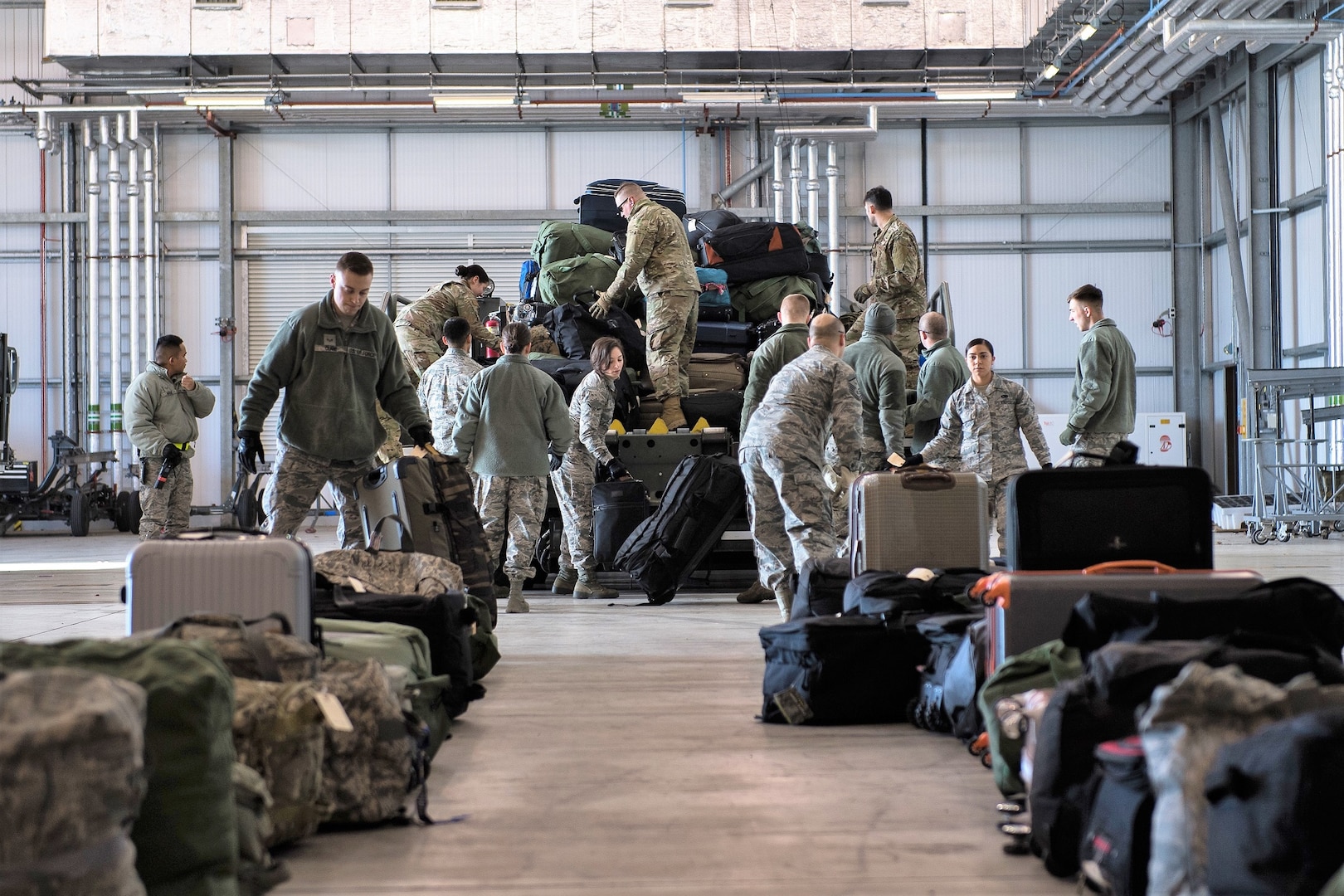 Airmen deployed from Barksdale Air Force Base, La., unload baggage at RAF Fairford, England, March 11, 2019. The Airmen deployed to support U.S. Strategic Command’s Bomber Task Force (BTF) in Europe which validates the readiness and capability of the command.