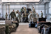 Airmen deployed from Barksdale Air Force Base, La., unload baggage at RAF Fairford, England, March 11, 2019. The Airmen deployed to support U.S. Strategic Command’s Bomber Task Force (BTF) in Europe which validates the readiness and capability of the command.