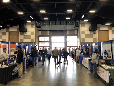 People visiting expo booths.