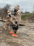 Two members of the 61st Civil Support Team, 87th Troop Command, Arkansas National Guard, don HAZMAT suits and search for chemical spills during a training exercise in West Memphis, Arkansas on March 13, 2019. The unit was involved in a New Madrid earthquake response exercise alongside several civilian emergency response agencies.