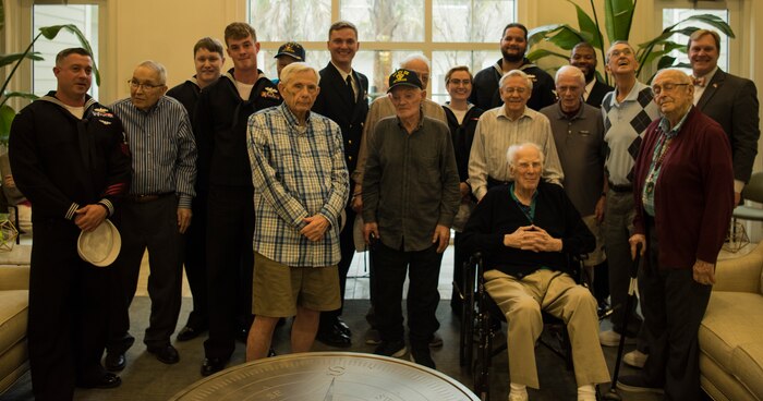 USS Charleston’s ship company stands with Vietnam, World War II and military veterans March 11, 2019, at the Somerby of Mount Pleasant, S.C., a senior living community.