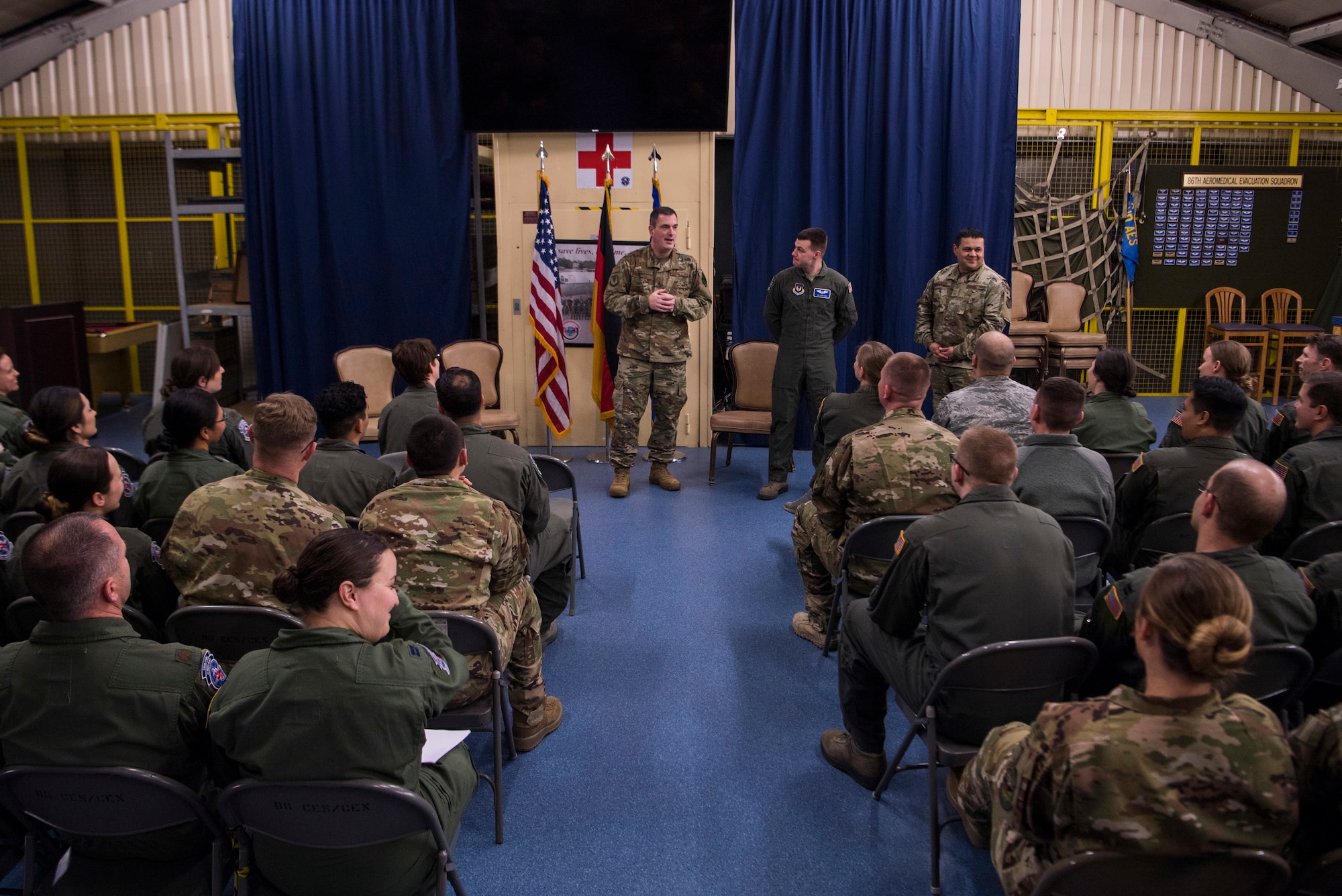 Members of the 86th Aeromedical Evacuation Squadron listen as U.S. Air Force Brig. Gen. Mark R. August, 86th Airlift Wing commander and Chief Master Sgt. Ernesto Rendon, 86th Airlift Wing command chief, speak on the accomplishments of Senior Airman Larry Nice, 86th Aeromedical Evacuation Squadron aeromedical evacuation technician, on Ramstein Air Base, Germany, March 14, 2019. Nice was recognized as Airlifter of the Week for demonstrating leadership abilities during a recent time crucial aeromedical evacuation mission.