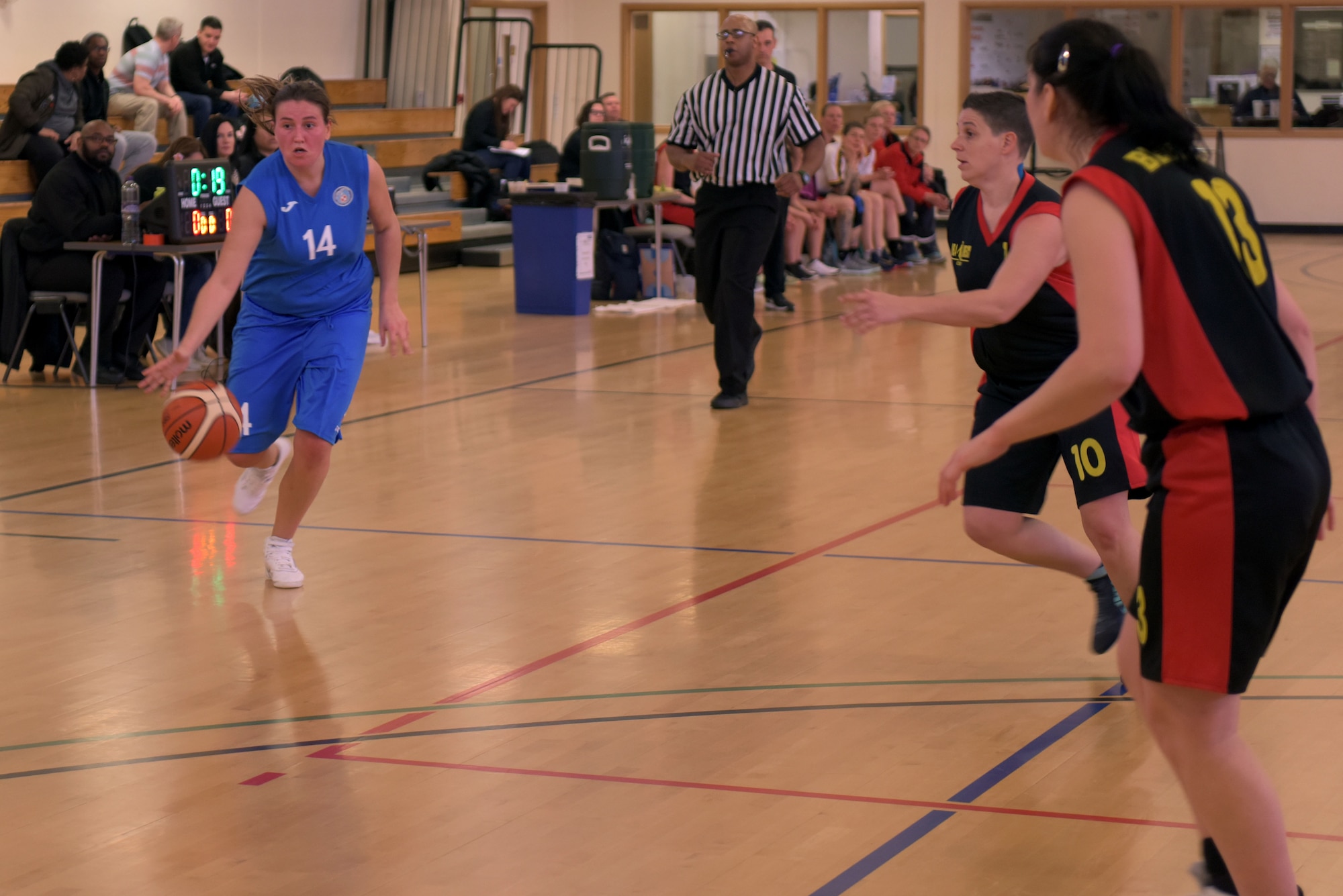 Polish air force Pvt. Angelika Popczyk dribbles the ball toward the basket at RAF Mildenhall, England, March 12, 2019. The aim of the Allied Air Command Sports Board mission is to encourage and assist the promotion of inter-nation sporting activities. (U.S. Air Force photo by Senior Airman Benjamin Cooper)