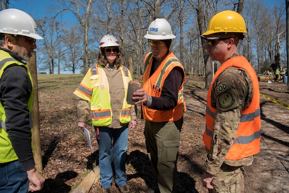 Don Coberley, URS-AECOM field project manager, shows a ground sample to U.S. Air Force Maj. Brandon Goebel, 20th CES commander, at Sans Souci Farm in Sumter, S.C., March 7, 2019.