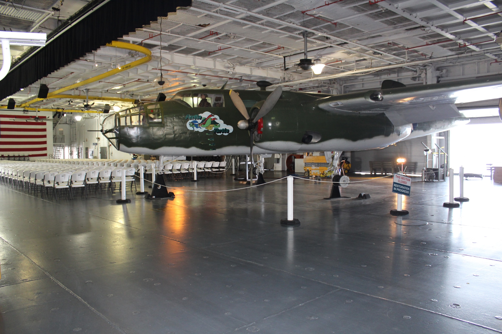 The B-25 “Furtle Turtle,” located on the hanger deck of the USS Yorktown at the Patriots Point Martime Museum in Mount Pleasant, S.C., sits supported by custom-built jack stands just before Airmen from the 437 Maintenance Group from Joint Base Charleston, S.C., reinstalled new wheels and tires.