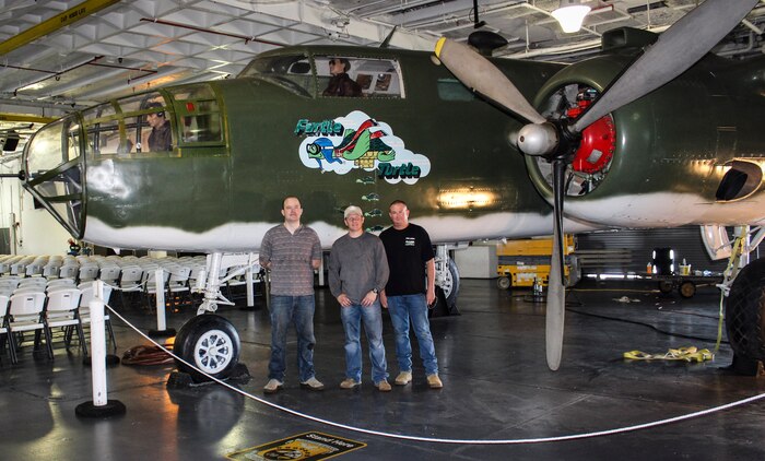 Left to right, Tech. Sgt. Richard Atchison, Master Sgt. Ron Williams and Tech. Sgt. Charles Long, all of the 437th Maintenance Group from Joint Base Charleston, S.C., pose in front of a B-25 bomber at Patriots Point Maritime Museum in Mount Pleasant, S.C.