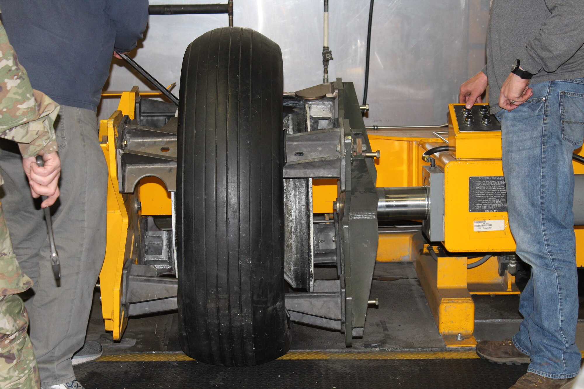 Members of the 437th Maintenance Group from Joint Base Charleston, S.C., utilize the aircraft tire bead breaker borrowed from the 437 MXS Aero Repair/Wheel and Tire Shop while working on a B-25 bomber at Patriots Point Maritime Museum in Mount Pleasant, S.C.