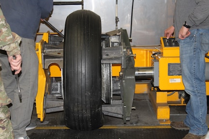 Members of the 437th Maintenance Group from Joint Base Charleston, S.C., utilize the aircraft tire bead breaker borrowed from the 437 MXS Aero Repair/Wheel and Tire Shop while working on a B-25 bomber at Patriots Point Maritime Museum in Mount Pleasant, S.C.