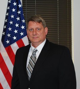 Wade Pasquarella standing next to flag.