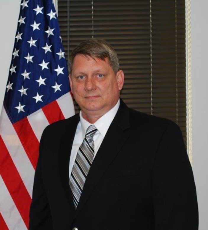 Wade Pasquarella standing next to flag.
