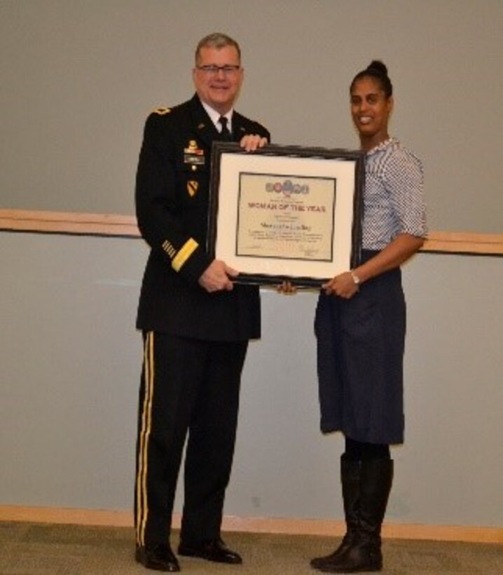 Army Brig. Gen. Mark Simerly, DLA Troop Support commander, left, presents Shevaughn Jorsling, right, Construction and Equipment supply chain supervisor, a plaque for her exemplary model of public service and government leadership during the Women’s History Month Program March 13. Jorsling was selected Woman of the Year in the supervisor/manager of the year category.  (Photo by Alexandria Brimage-Gray)