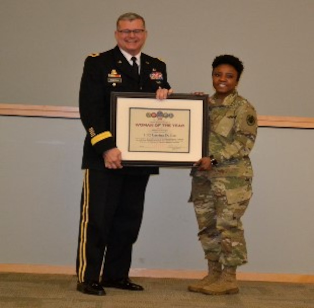 Army Brig. Gen. Mark Simerly, DLA Troop Support commander, left, presents Army Lt. Col. Latrina Lee, J3/5 supervisor, a plaque for her exemplary model of public service and government leadership during the Women’s History Month Program March 13. Lee was selected Woman of the Year in the supervisor/manager of the year category. (Photo by Alexandria Brimage-Gray)
