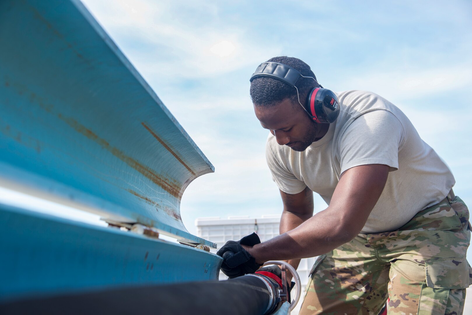 U.S. Air Force Senior Airman Shaquille Roberts, a 6th Logistics Readiness Squadron fuels distribution technician, secures a fuel hose at MacDill Air Force Base, Fla., March 14, 2019.