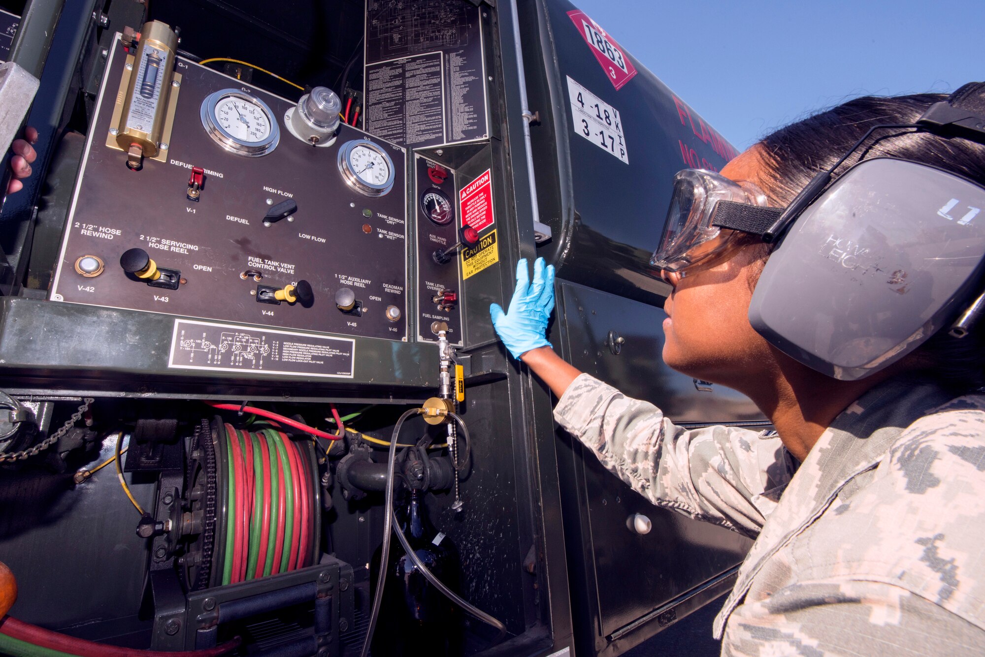 U.S. Air Force Staff Sgt. Akila Mohabir, the 6th Logistics Readiness Squadron fuels laboratory technician, withdraws fuel from a R-11 fuel truck at MacDill Air Force Base, Florida, March 14, 2019.