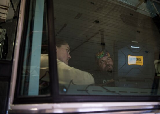 Image of Mr. Kent Kleffner, 366 Logistics Readiness Squadron automative service excellence master technician, trains Staff Sgt. Jory Fueston, 366 LRS vehicle management technician, on how to use their new vehicle diagnostic tool. This tool is capatable with a large variety of vehicles, enabling LRS to save resources by performing diagnostic maintenance in-house.