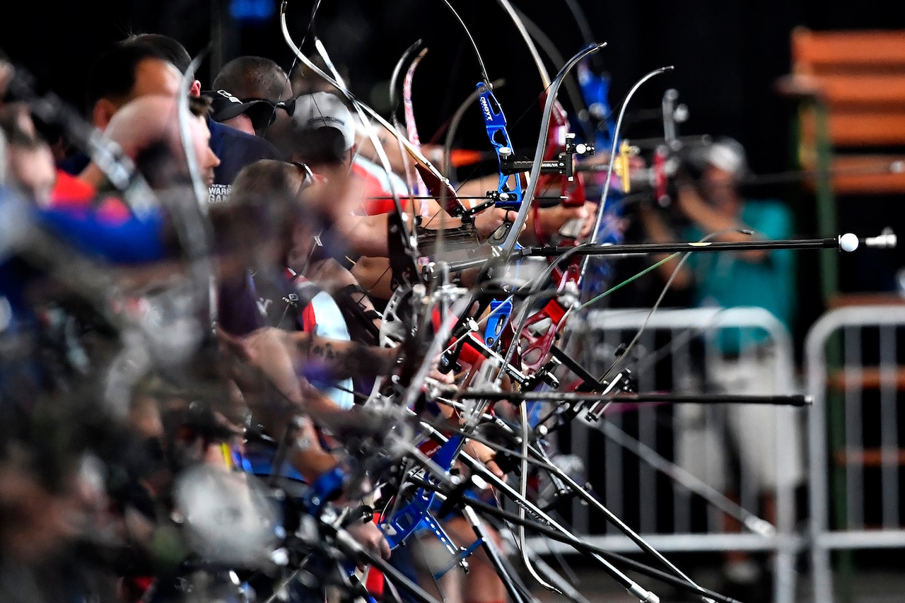 Athletes prepare to shoot arrows.