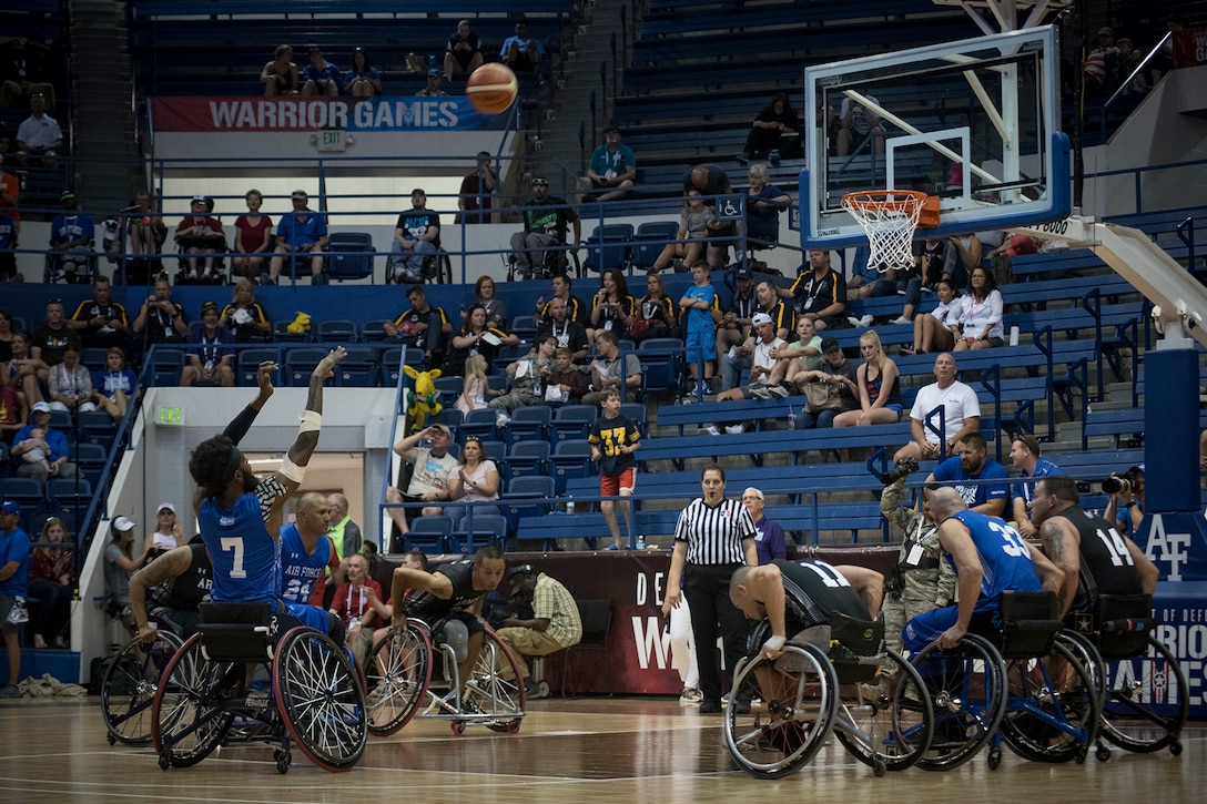 Athletes play wheelchair basketball.