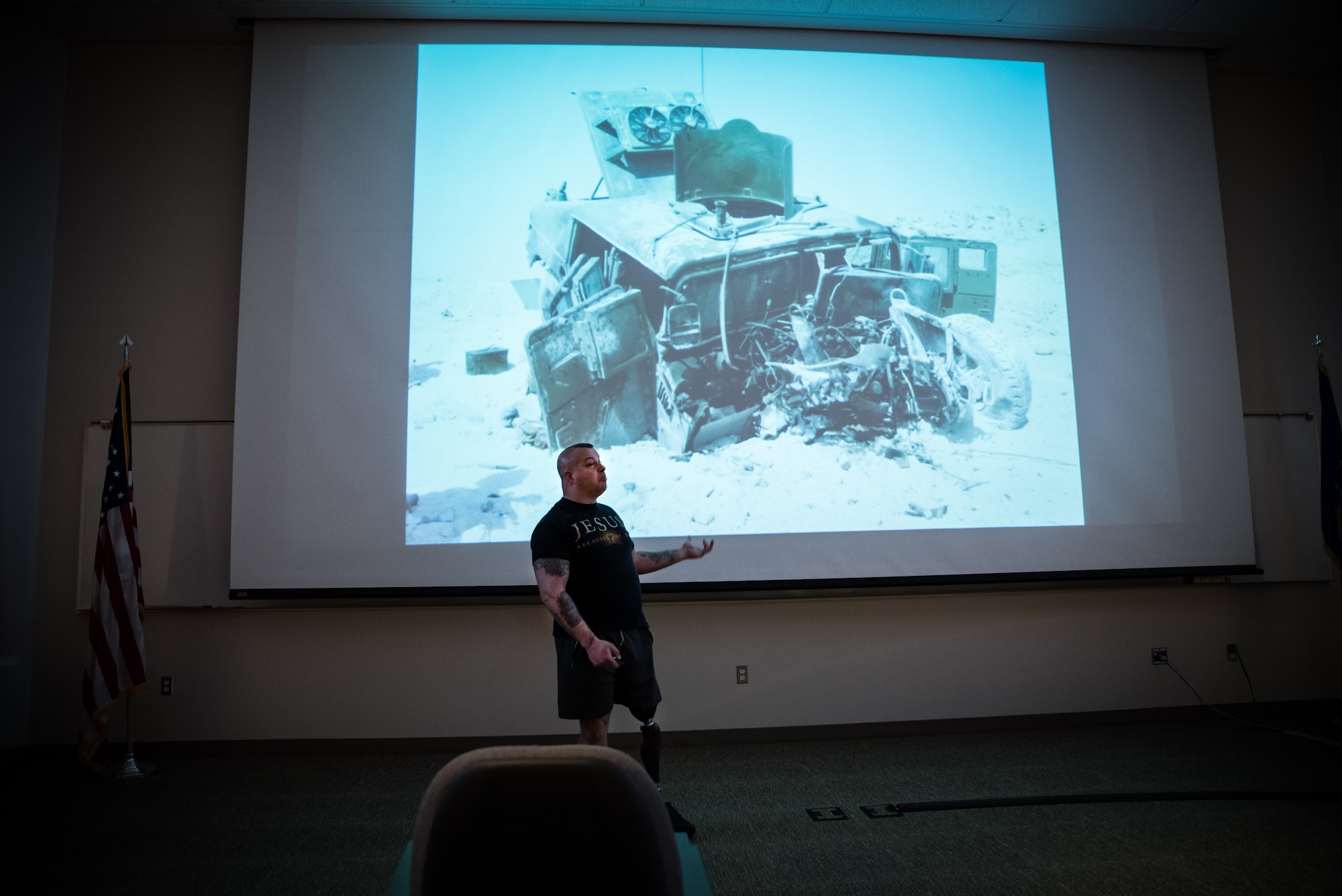 Marine Corps Staff Sgt. (Ret.) Daniel Gilyeat, who lost his left leg in an explosion in July 2005 when his Up Armored Humvee ran over a double-stacked anti-tank mine on a dusty battlefield in Iraq, speaks to students of the Aerospace Medicine Primary course at the United States Air Force School of Aerospace Medicine March 4. Gilyeat was presenting a photo of what his vehicle looked like after the explosion. (U.S. Air Force photo/Richard Eldridge)