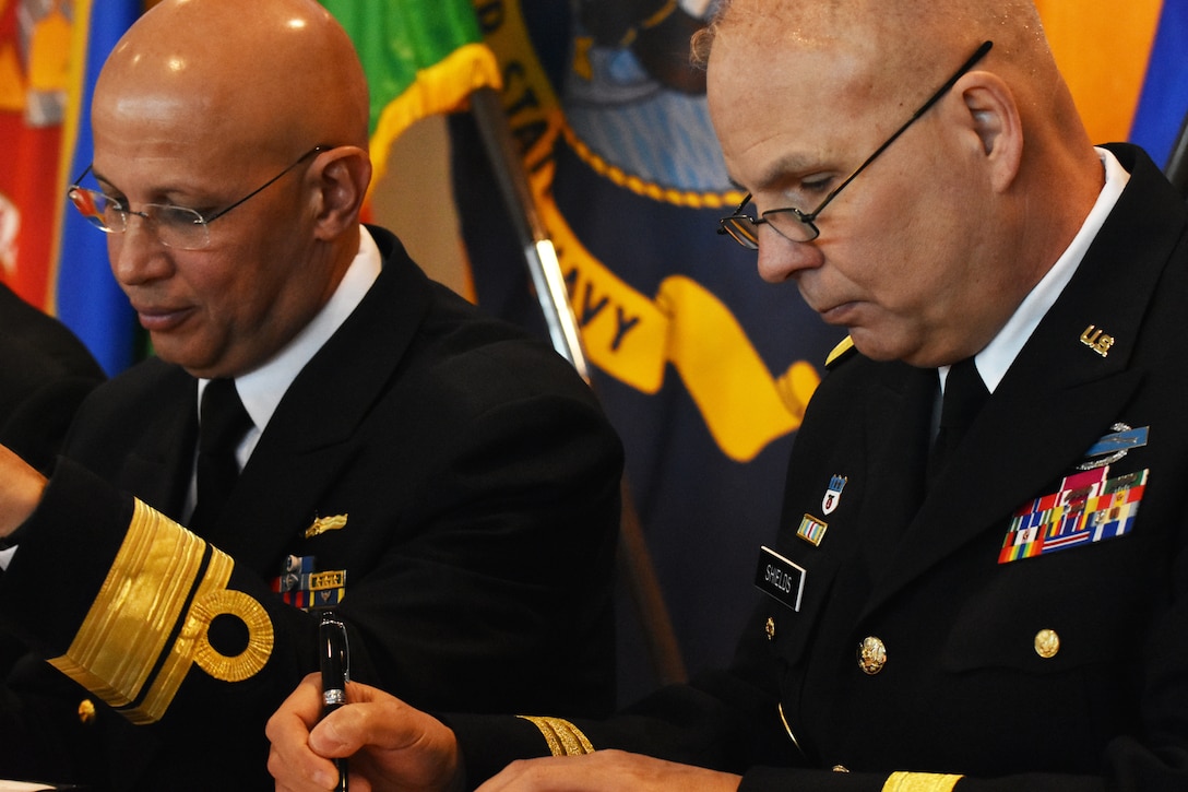 Chief of International Affairs at the Brazil Ministry of Defense, Rear Admiral Guilherme Da Silva Costa (left) and New York National Guard Adjutant Gen., Maj. Gen. Raymond Shield (right), sign a state partnership agreement, on the U.S.S. Intrepid, Manhattan, N.Y., March 14, 2019.