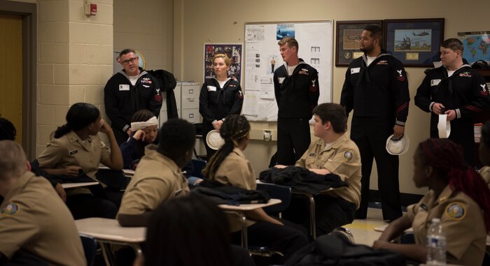 Members of the USS Charleston’s ship’s company talk to JROTC students at North Charleston High School during a Navy Week school visit March 13, 2019, in North Charleston, S.C.