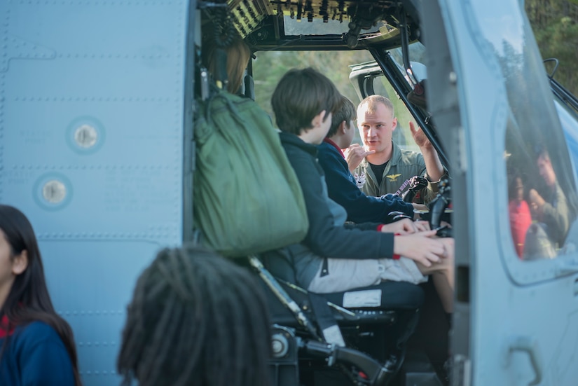 Lt. Justin Norris, a Helicopter Maritime Strike Squadron Four-Zero fleet replacement instructor pilot, talks to students about the helicopter during a Navy Week school visit March 14, 2019, in John’s Island, S.C.