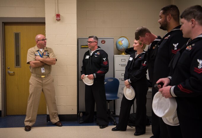 Retired Master Chief Petty Officer Brantley Altman, left, JROTC instructor for North Charleston High School, talks to some of the USS Charleston’s ship’s company during a Navy Week school visit March 13, 2019, in North Charleston, S.C.