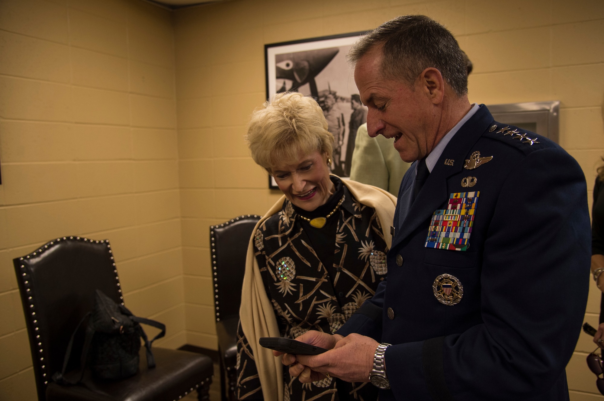 Air Force Chief of Staff Gen. David L. Goldfein shows pictures of his grandchildren to Dr. Lucy Greene before the Celebration of Life ceremony honoring Mr. W. Parker Greene, March 14, 2019, at Moody Air Force Base, Ga. Greene, a steadfast Air Force advocate and one of the most influential military civic leaders passed away Dec. 18, 2018. (U.S. Air Force Photo by Andrea Jenkins)