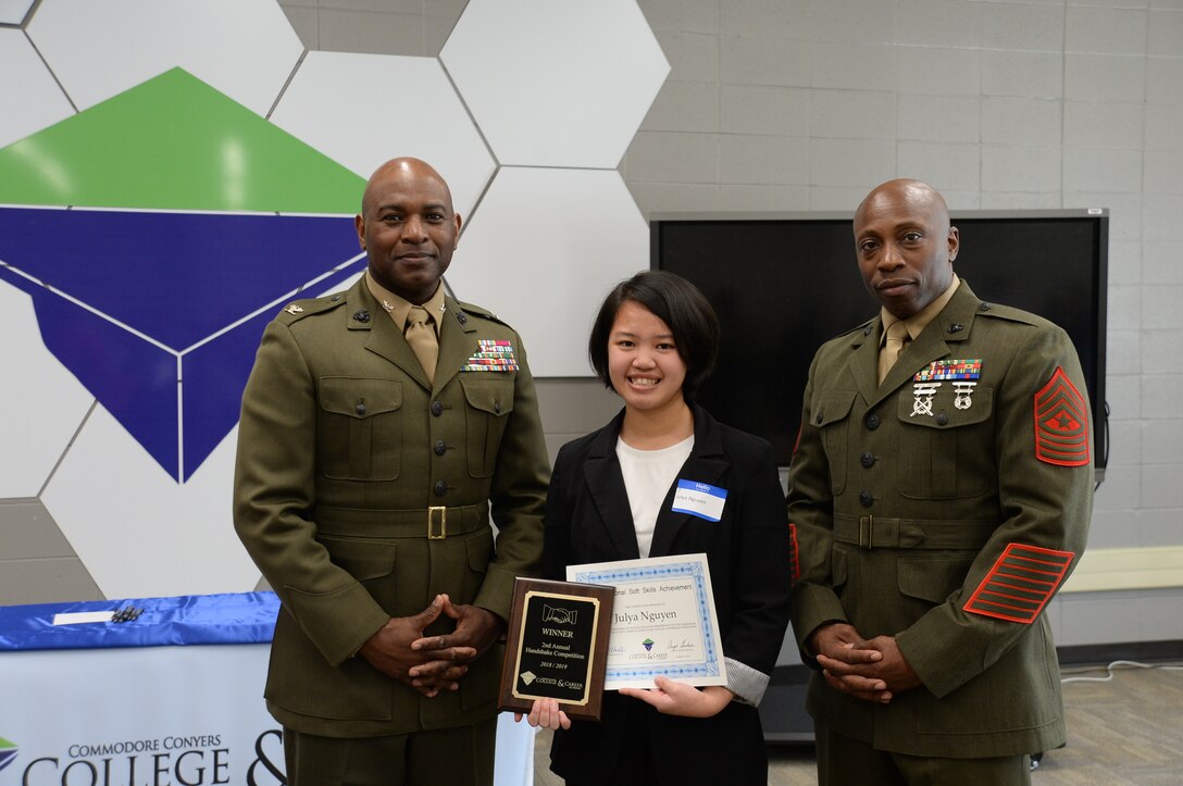 Col. Alphonso Trimble, commanding officer, and Sgt.Maj. Johnny Higdon, base sergeant major, joined other community leaders for the second annual handshake competition at the Commodore Conyers College and Career Academy, March 13.