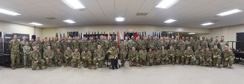 Battalion command team members and staff from the 85th U.S. Army Reserve Support Command and First Army pause for a photo with World War II Veteran, Al Mampre, during the last day of the 85th USARSC’s Battalion Commanders Huddle briefing, Mar. 10, 2019.