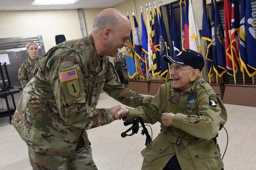 Army Reserve Command Sgt. Maj. Gilbert Garrett, left, command sergeant major of the 2nd Battalion, 337 Regiment, 85th U.S. Army Reserve Support Command, operationally controlled by 157th Infantry Brigade, meets World War II Veteran, Al Mampre, during the last day of the 85th USARSC’s Battalion Commanders Huddle briefing, Mar. 10, 2019.