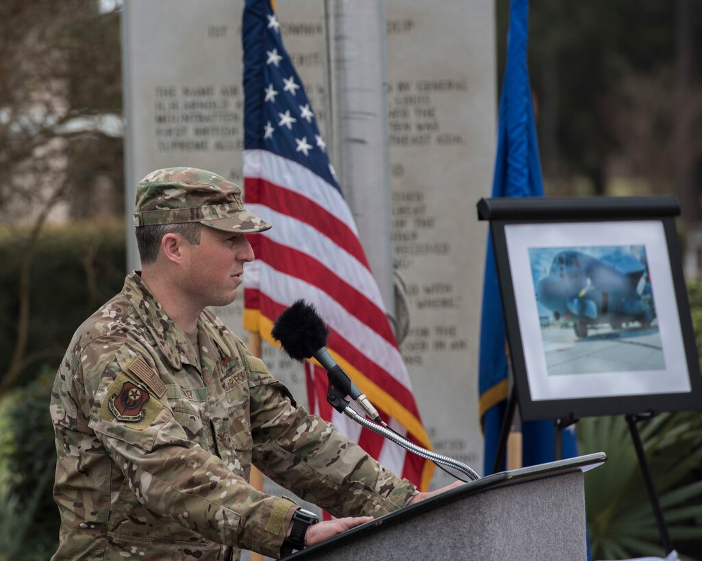 Colonel speaking at a podium outside.