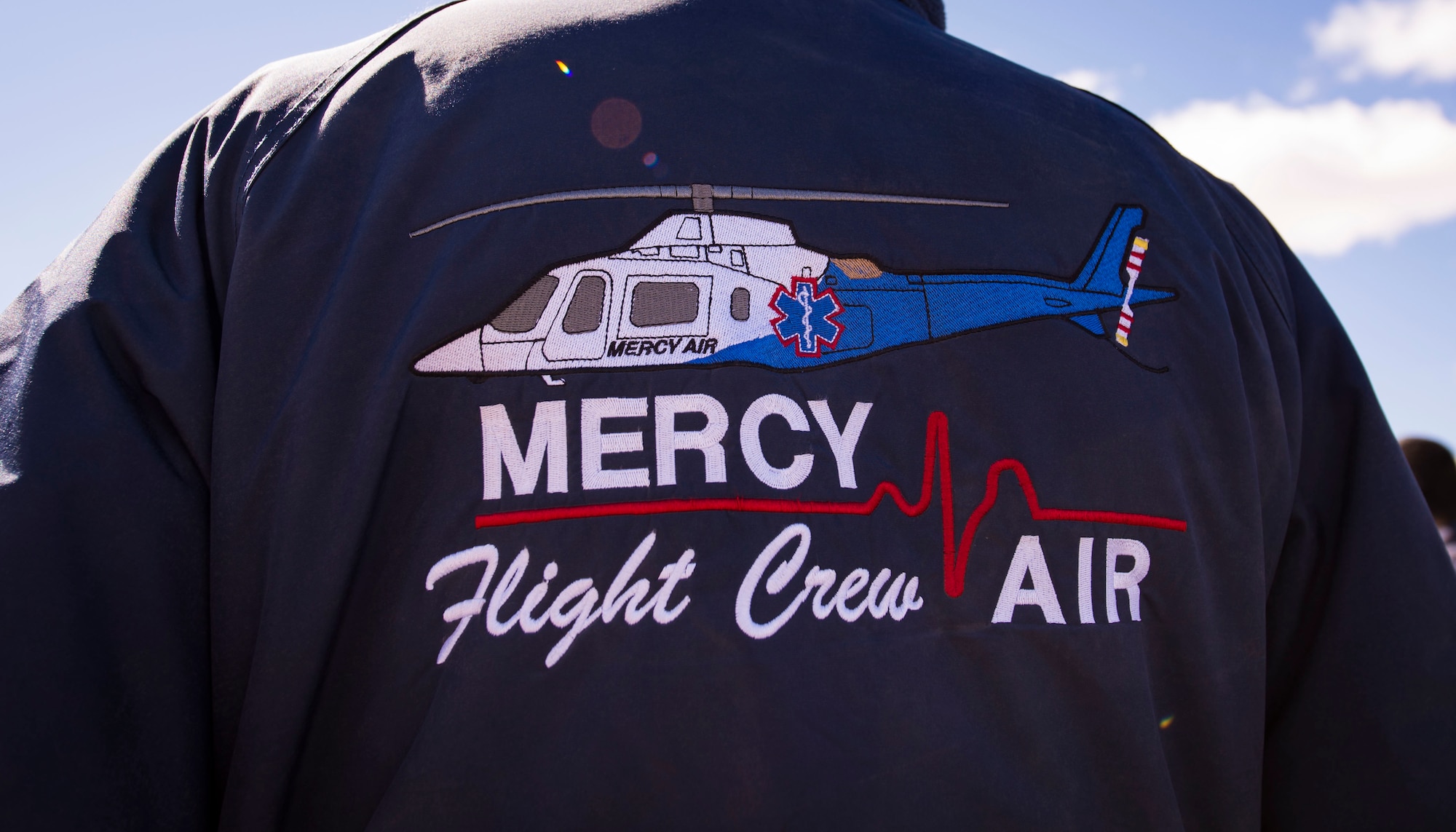 A man wears a Mercy Air Flight Crew jacket.