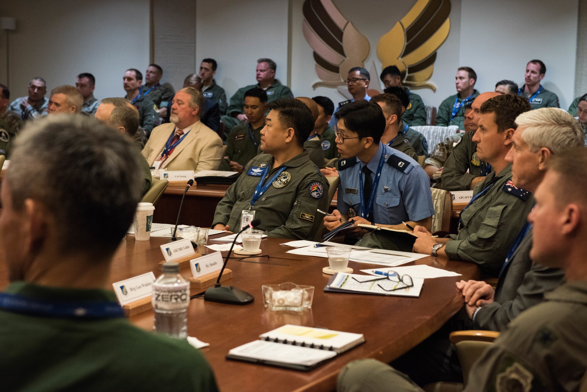 Members of the Pacific F-35 Users Group Conference listen to opening remarks given by the Pacific Air Forces commander at Headquarters PACAF, Joint Base Pearl Harbor-Hickam, Hawaii, March 12, 2019.