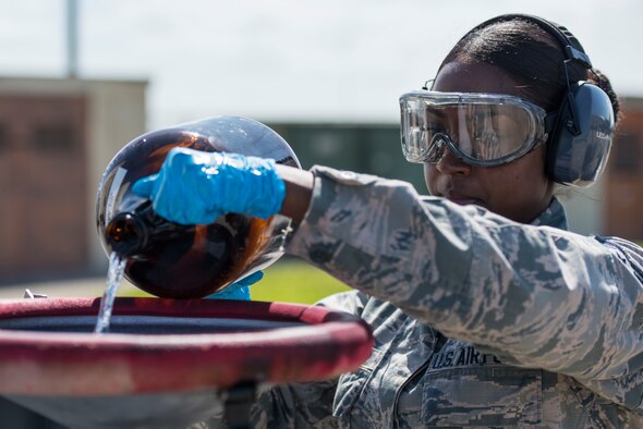 U.S. Air Force Staff Sgt. Akila Mohabir, a 6th Logistics Readiness Squadron fuels laboratory technician, pours excess fuel in a fuel storage tank at MacDill Air Force Base, Fla., March 14, 2019.
