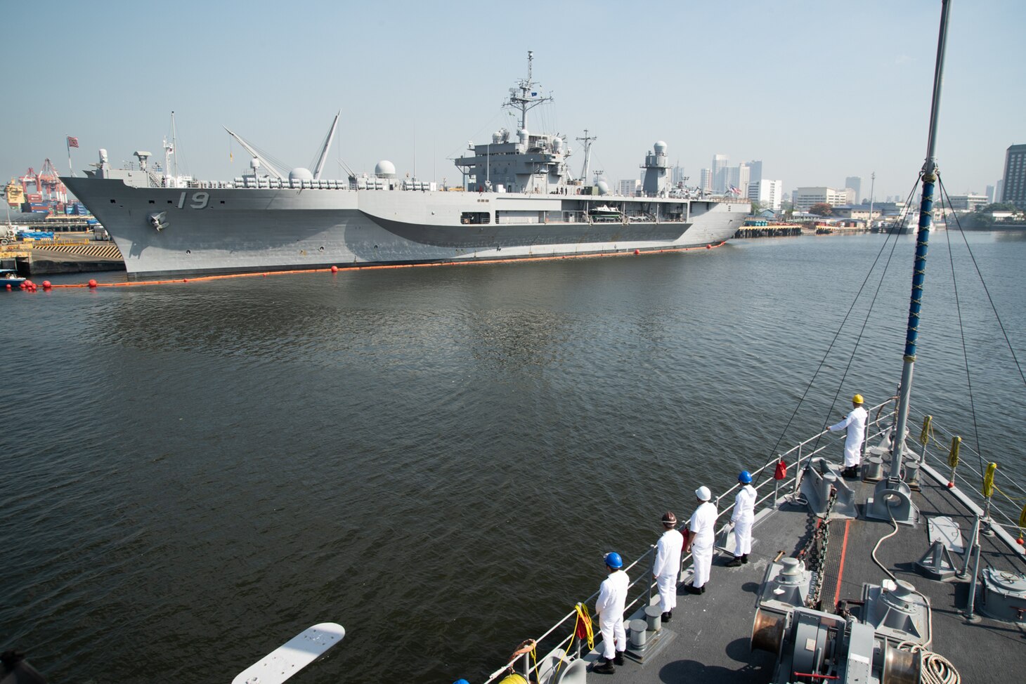 MANILA, Philippines (March 17, 2019) Sailors aboard the Avenger class mine countermeasures ship USS Chief (MCM 14) prepare to render honors to U.S. 7th Fleet Flagship USS Blue Ridge (LCC 19) while arriving in Manila, Philippines, for a port visit. Chief is visiting Manila while operating in the U.S. 7th Fleet area of operations to work with their Philippine Navy counterparts to strengthen regional security and stability, and enhance interoperability.