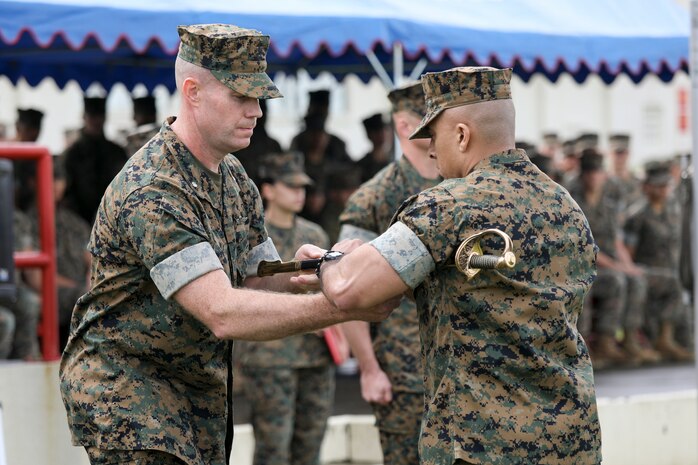 Lt. Col. Matthew Mulvey, left, ceremoniously passes the non-commissioned officer sword to Sgt. Maj. Jose A. Beltran, right, during a relief and appointment ceremony for 3rd Transportation Support Battalion, Combat Logistics Regiment 3, 3rd Marine Logistics Group at Camp Foster, Okinawa, Japan March 15, 2019. Sgt. Maj. Jeffery J. Vandentop ceremoniously transferred accountability and authority of enlisted Marines to Sgt. Maj. Jose A. Beltran during the ceremony. Mulvey, the commanding officer of 3rd TSB, CLR-3, 3rd MLG, is a native of Cherryville, North Carolina. Beltran, the battalion sergeant major for 3rd TSB, is a native of Puerto Rico. (U.S. Marine Corps photo by Lance Cpl. Armando Elizalde)