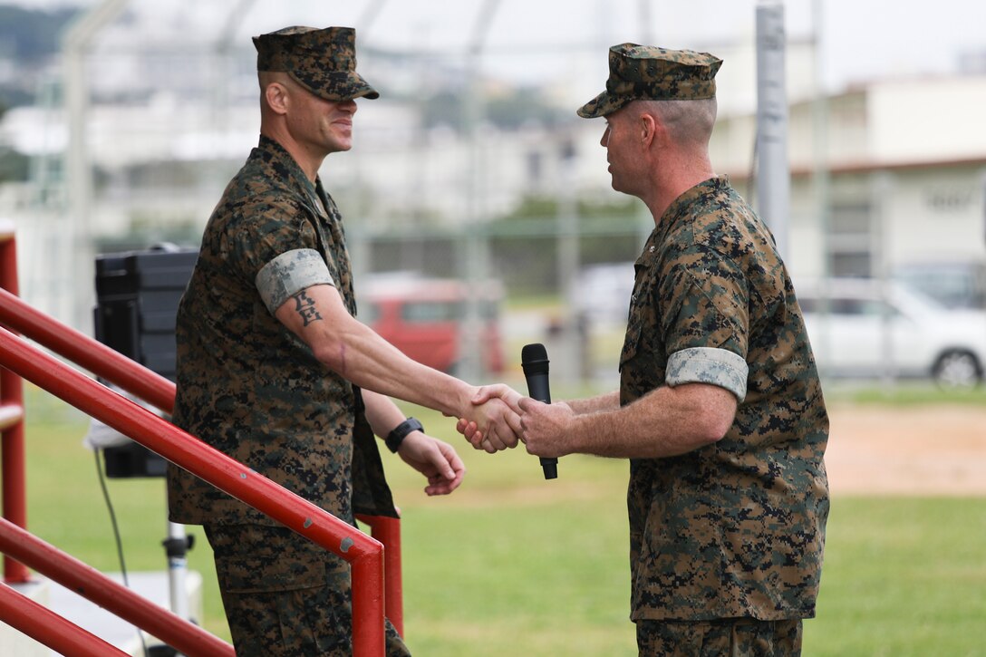 Lt. Col. Matthew Mulvey, right, thanks Sgt. Maj. Jeffery J. Vandentop, left, during a relief and appointment ceremony for 3rd Transportation Support Battalion, Combat Logistics Regiment 3, 3rd Marine Logistics Group at Camp Foster, Okinawa, Japan March 15, 2019. Vandentop ceremoniously transferred accountability and authority of enlisted Marines to Sgt. Maj. Jose A. Beltran during the ceremony. Mulvey, the commanding officer of 3rd TSB, CLR-3, 3rd MLG, is a native of Cherryville, North Carolina. Vandentop is a native of Toronto, Canada. (U.S. Marine Corps photo by Lance Cpl. Armando Elizalde)