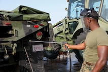 U.S. Marine Corps Lance Cpl. Martin Coggins, pressure washes a Medium Tactical Vehicle Replacement 7-Ton March 13, 2019 on Camp Kinser, Okinawa, Japan. The MTVR 7-Ton is one of many pieces of equipment that will be cleaned, inspected and then shipped for use in Australia by the Marine Rotational Force – Darwin Marine Air-Ground Task Force. Coggins, an electrical engineer with Engineer Maintenance Company, Combat Logistics Battalion 4, 3rd Marine Logistics Group, is a native of Bronx, New York. (U.S. Marine Corps photo by Cpl. Isabella Ortega)