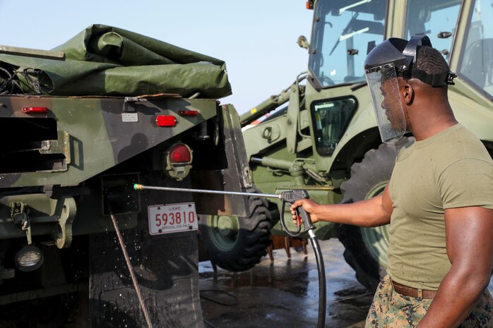 U.S. Marine Corps Lance Cpl. Martin Coggins, pressure washes a Medium Tactical Vehicle Replacement 7-Ton March 13, 2019 on Camp Kinser, Okinawa, Japan. The MTVR 7-Ton is one of many pieces of equipment that will be cleaned, inspected and then shipped for use in Australia by the Marine Rotational Force – Darwin Marine Air-Ground Task Force. Coggins, an electrical engineer with Engineer Maintenance Company, Combat Logistics Battalion 4, 3rd Marine Logistics Group, is a native of Bronx, New York. (U.S. Marine Corps photo by Cpl. Isabella Ortega)