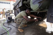 U.S. Marine Corps Lance Cpl. Martin Coggins pressure washes the underside of a Medium Tactical Vehicle Replacement 7-Ton March 13, 2019 on Camp Kinser, Okinawa, Japan. The MTVR 7-Ton is one of many pieces of equipment that will be cleaned, inspected and then shipped for use in Australia by the Marine Rotational Force – Darwin Marine Air-Ground Task Force. Coggins, an electrical engineer with Engineer Maintenance Company, Combat Logistics Battalion 4, 3rd Marine Logistics Group, is a native of Bronx, New York. (U.S. Marine Corps photo by Cpl. Isabella Ortega)