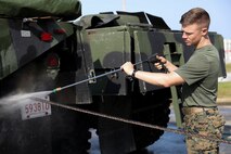 U.S. Marine Corps Pfc. Richard Baxley pressure washes a Medium Tactical Vehicle Replacement 7-Ton tow cable March 13, 2019 on Camp Kinser, Okinawa, Japan. The MTVR 7-Ton is one of many pieces of equipment that will be cleaned, inspected and then shipped for use in Australia by the Marine Rotational Force - Darwin Marine Air-Ground Task Force. Baxley, a heavy equipment operator with Heavy Equipment Operations Platoon, Engineer Support Company, 9th Engineer Support Battalion, 3rd Marine Logistics Group, is a native of Lakeland, Florida. (U.S. Marine Corps photo by Cpl. Isabella Ortega)